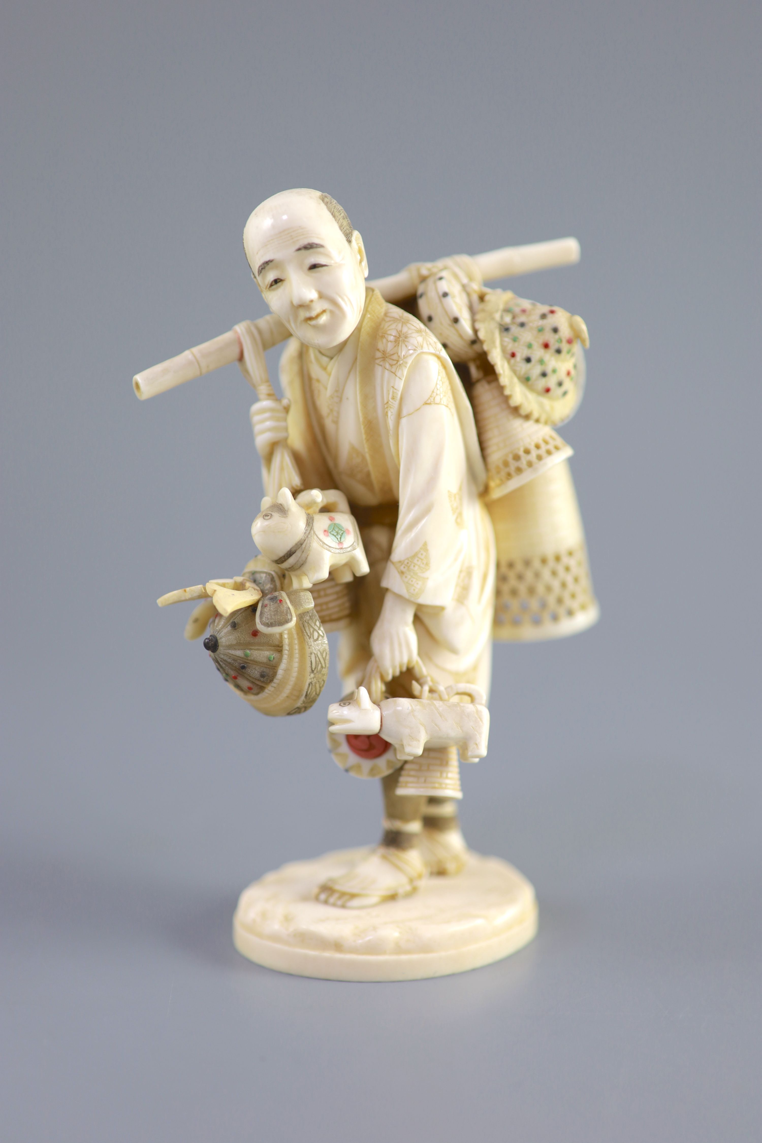 A Japanese ivory okimono of a basket seller, early 20th century 14.5 cm high